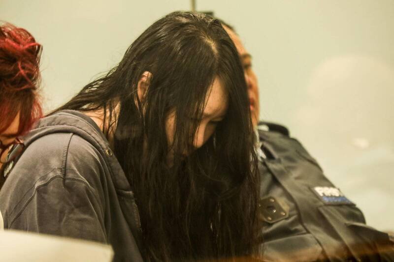 纽西兰「行李箱藏尸案」被告、韩裔女子李河景（Hakyung Lee）26日在奥克兰高等法院聆听判决时全程低头。她因毒杀两名子女并藏尸行李箱长达4年，遭判处终身监禁。（法新社）