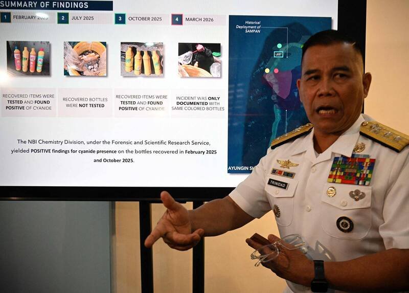 菲律宾海军发言人特立尼达（Roy Vincent Trinidad）13日召开记者会，展示在仁爱暗沙水域查获、疑似含有氰化物的黄色瓶装物。（法新社）
